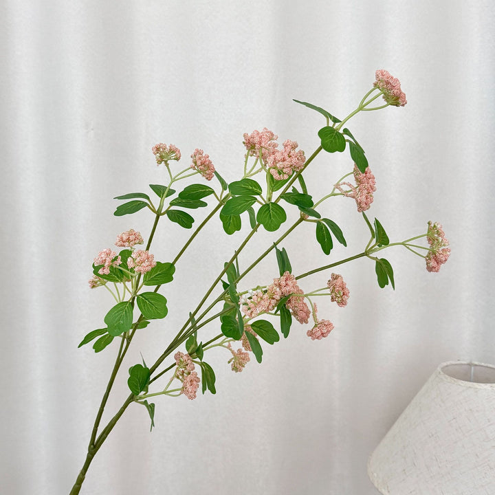 Artificial blossom branch with purple flowers