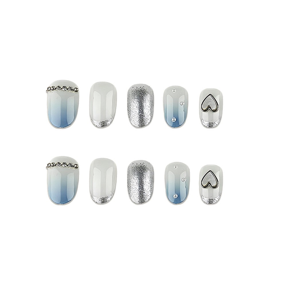 Glamorous artificial nails with heart design and pearl details Kalsten