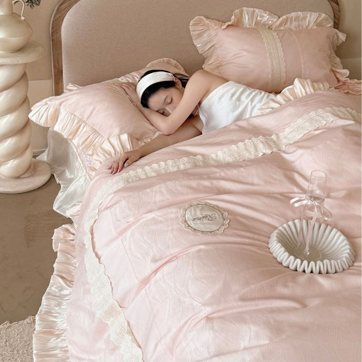 Duvet cover set with ruffle trim, fine lace border, and subtle jacquard structure
