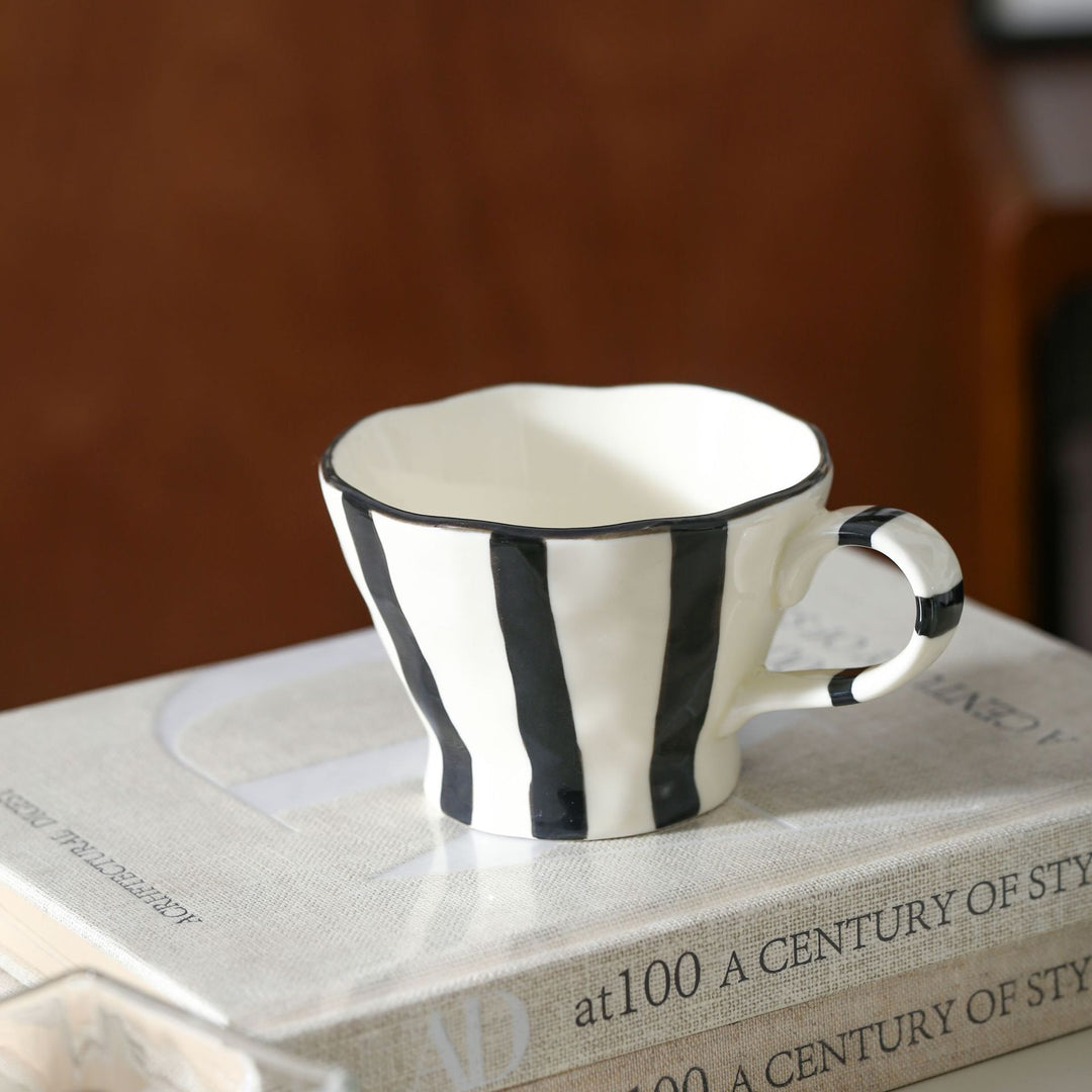 Designer stoneware coffee mug with scalloped rim and vertical brushstroke
