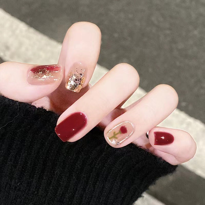 Elegant nail design with floral and sparkling accents Kalsten