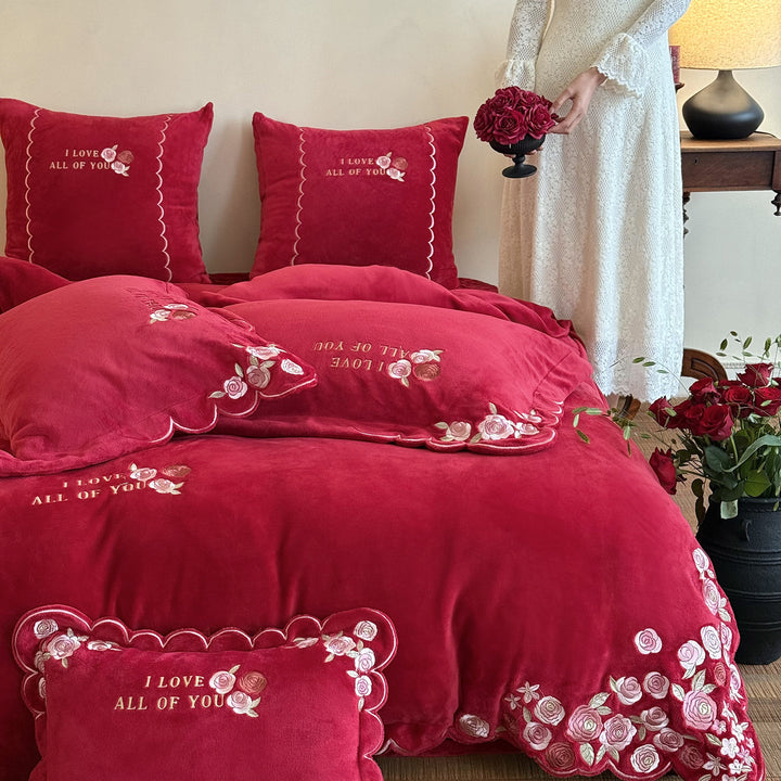 Soft-touch bedding set with floral rose embroidery, wavy hem, and reversible pillow.