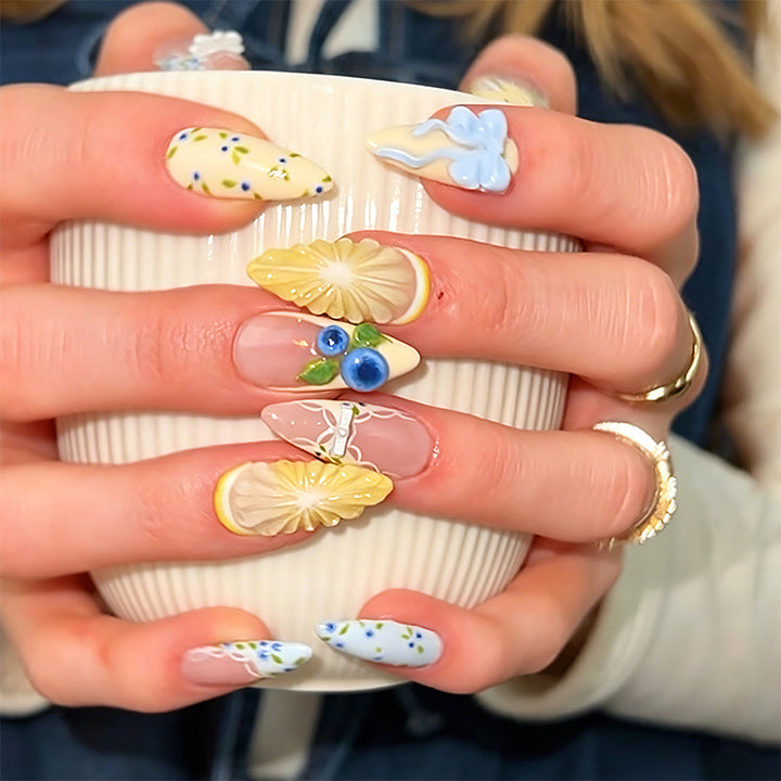 Artificial nail set with glamorous floral designs and creative glitter accents Kalsten