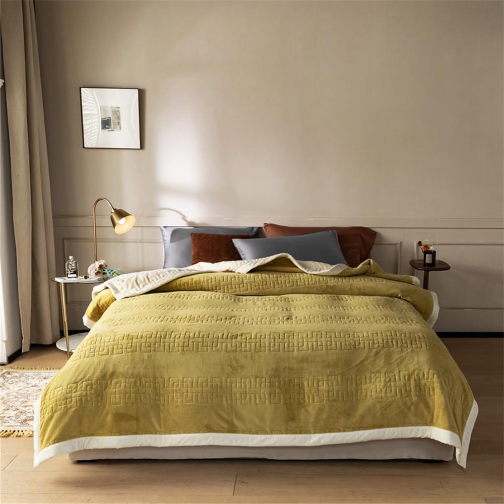 Reversible quilted comforter with structured box stitching and cotton trim