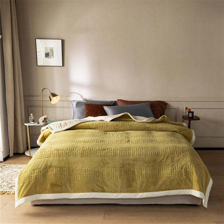 Reversible quilted comforter with structured box stitching and cotton trim