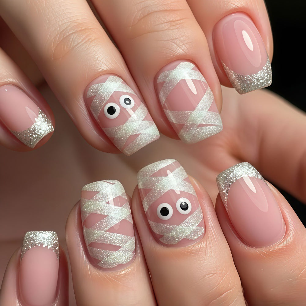 Artificials nails with playful eye design and glitter tips Kalsten