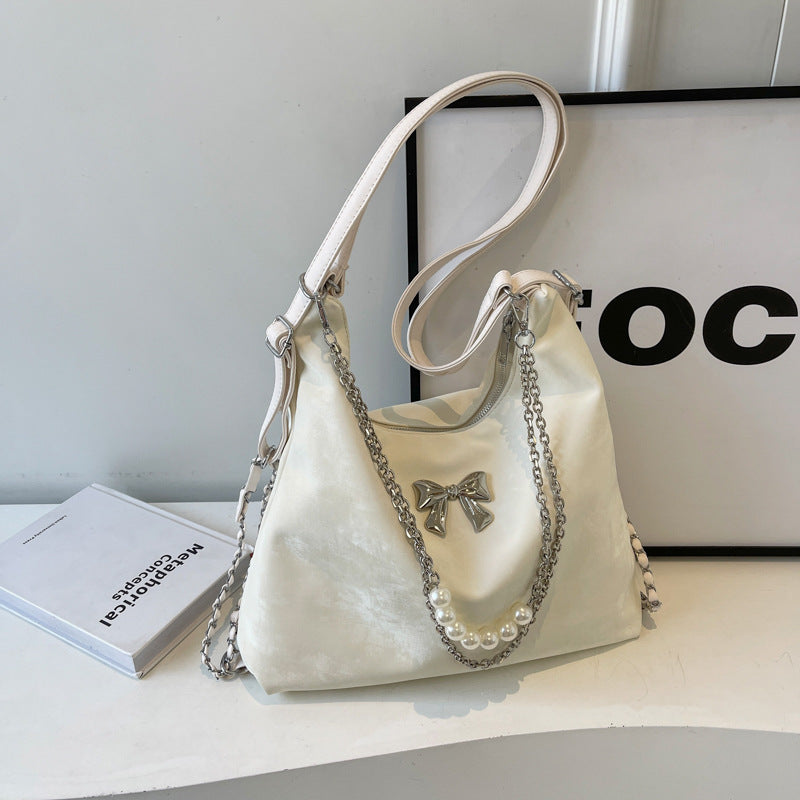 Fashionable handbag with unique pendant and chain accents Kalsten