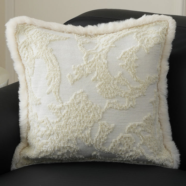 Square decorative pillow with embossed circular relief and soft faux fur edging