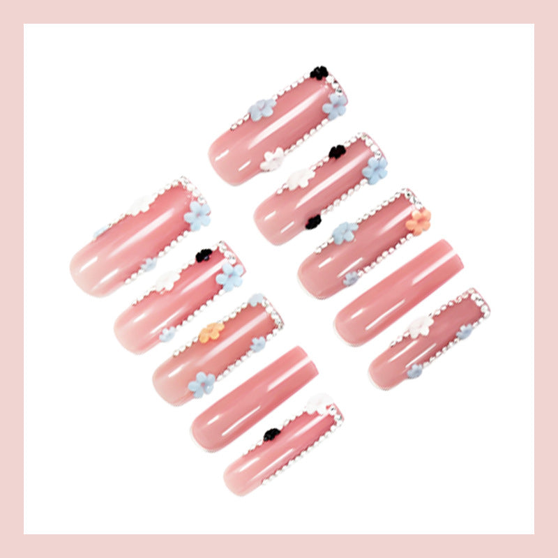 Artificial nail art set with floral decorations and glitter accents Kalsten