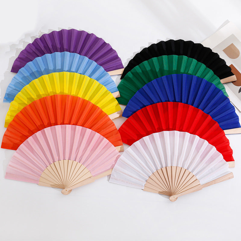 Ladies folding hand fan made of airy material with intricate folds Kalsten
