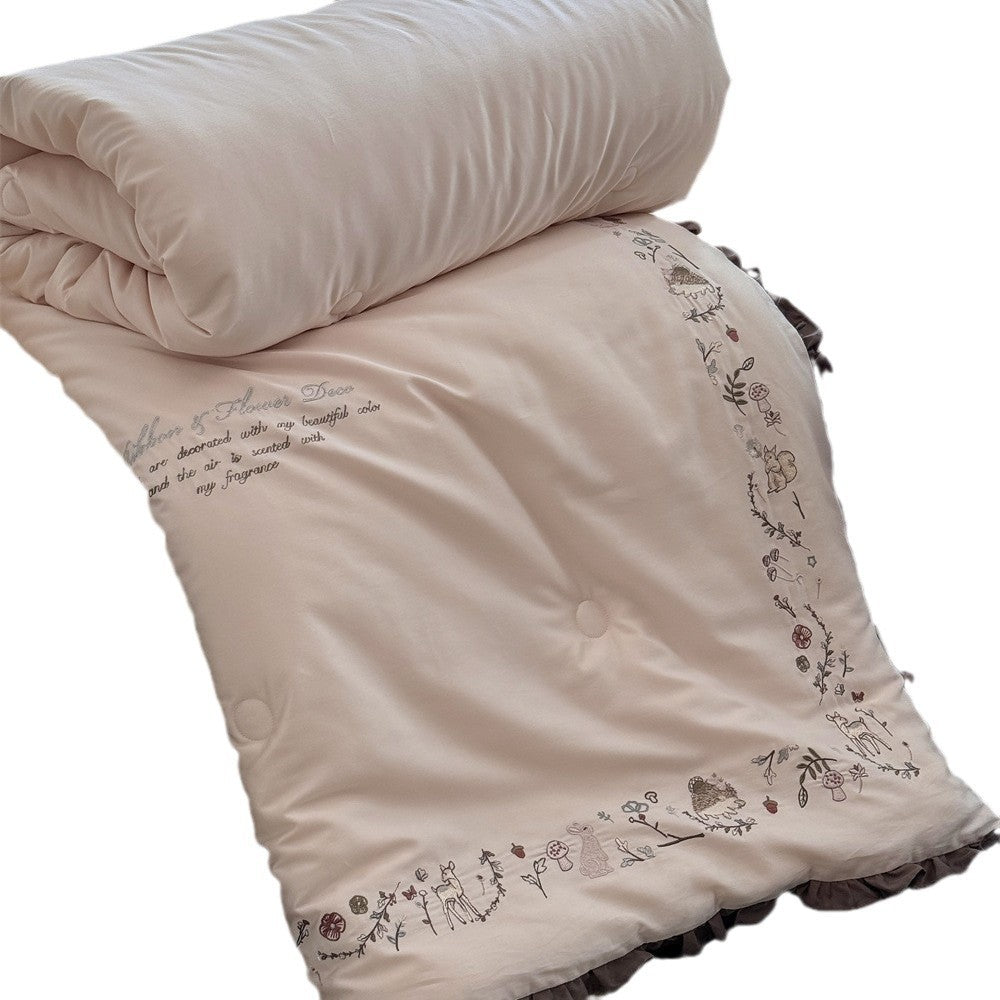 Quilted reversible duvet cover with floral embroidery and ruffled hem
