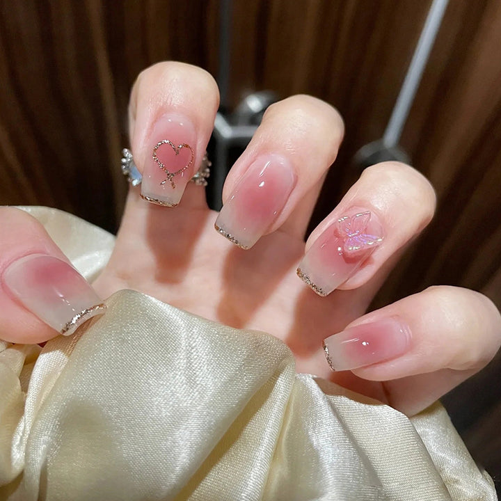 Glamorous artificial nails with heart and glitter details Kalsten