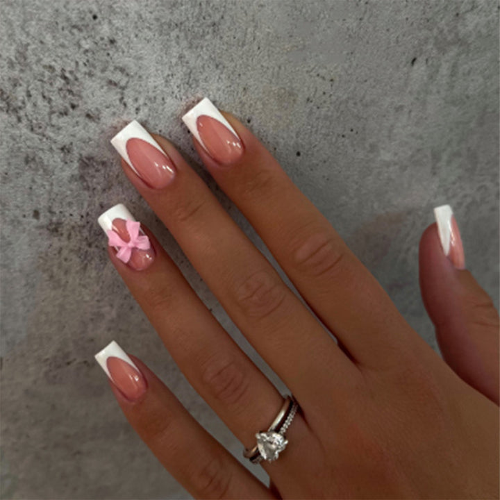 Acrylic nail set with elegant tips and playful bows Kalsten