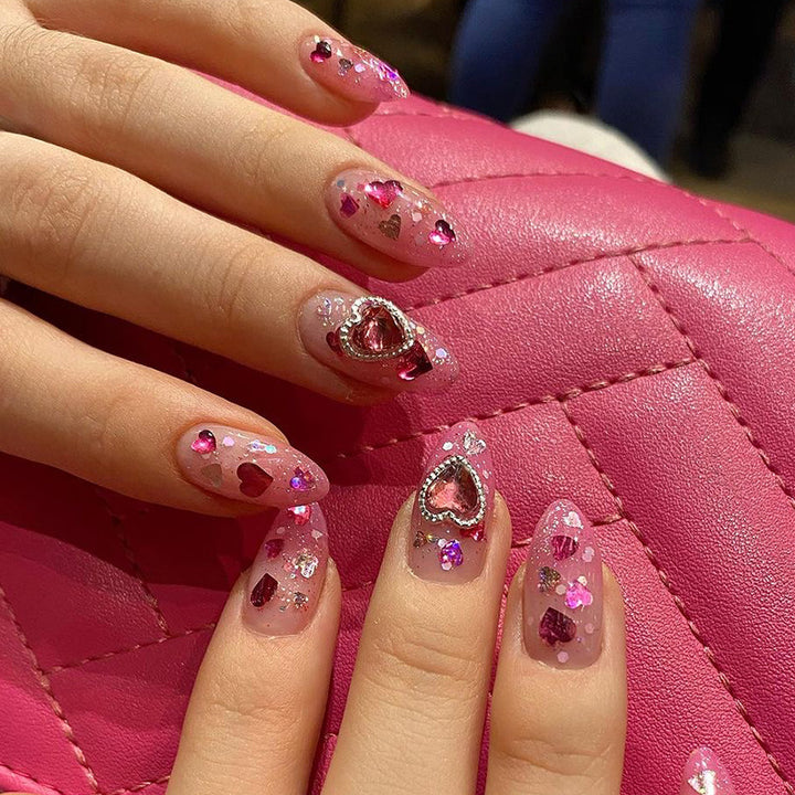 Artful nail art with playful heart designs and glitter Kalsten