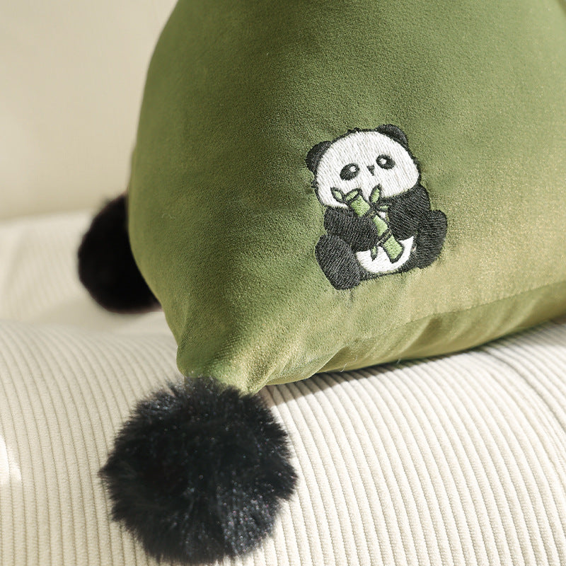 Pyramid-shaped triangle cushion with faux fur pom-poms and zebra embroidery