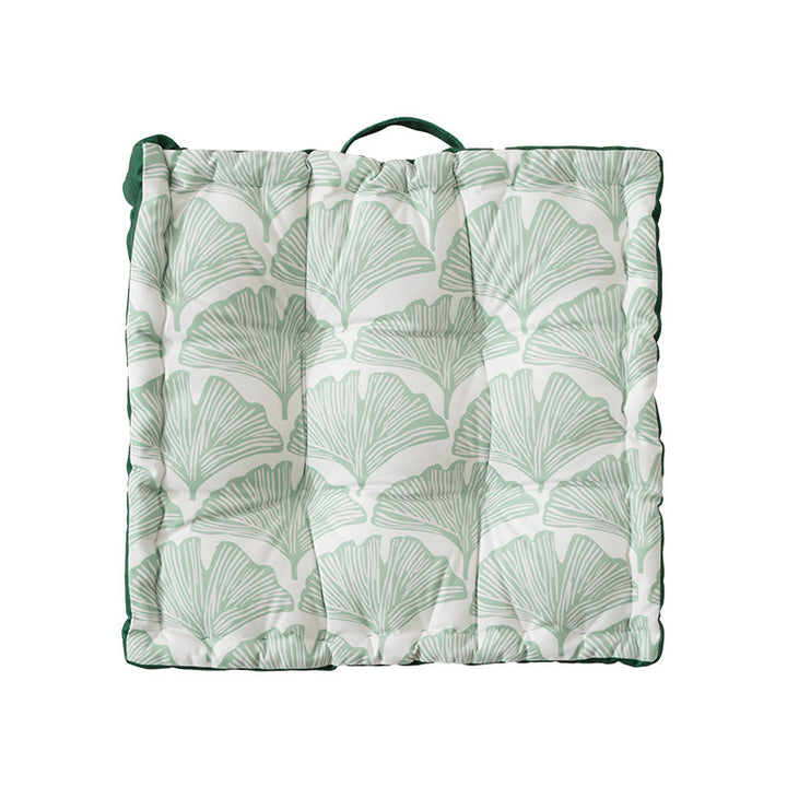 Padded floor cushion with quilted tufting, floral motif and carrying handle