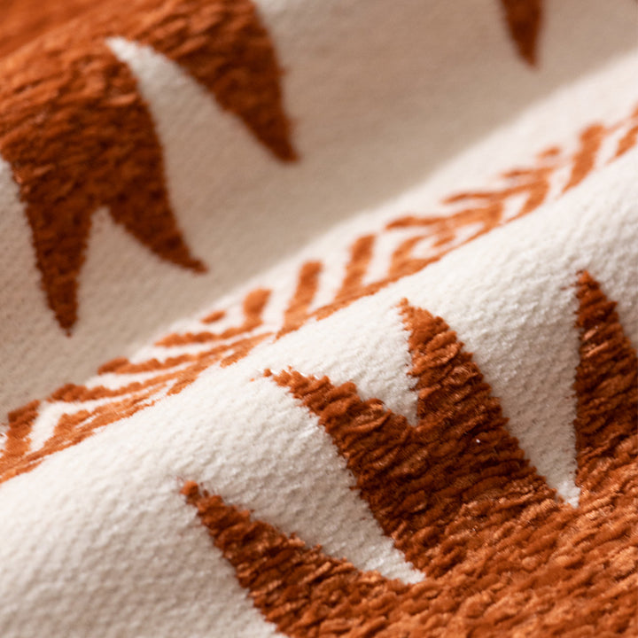 Woven cushion cover with graphic ethnic pattern and contrasting borders
