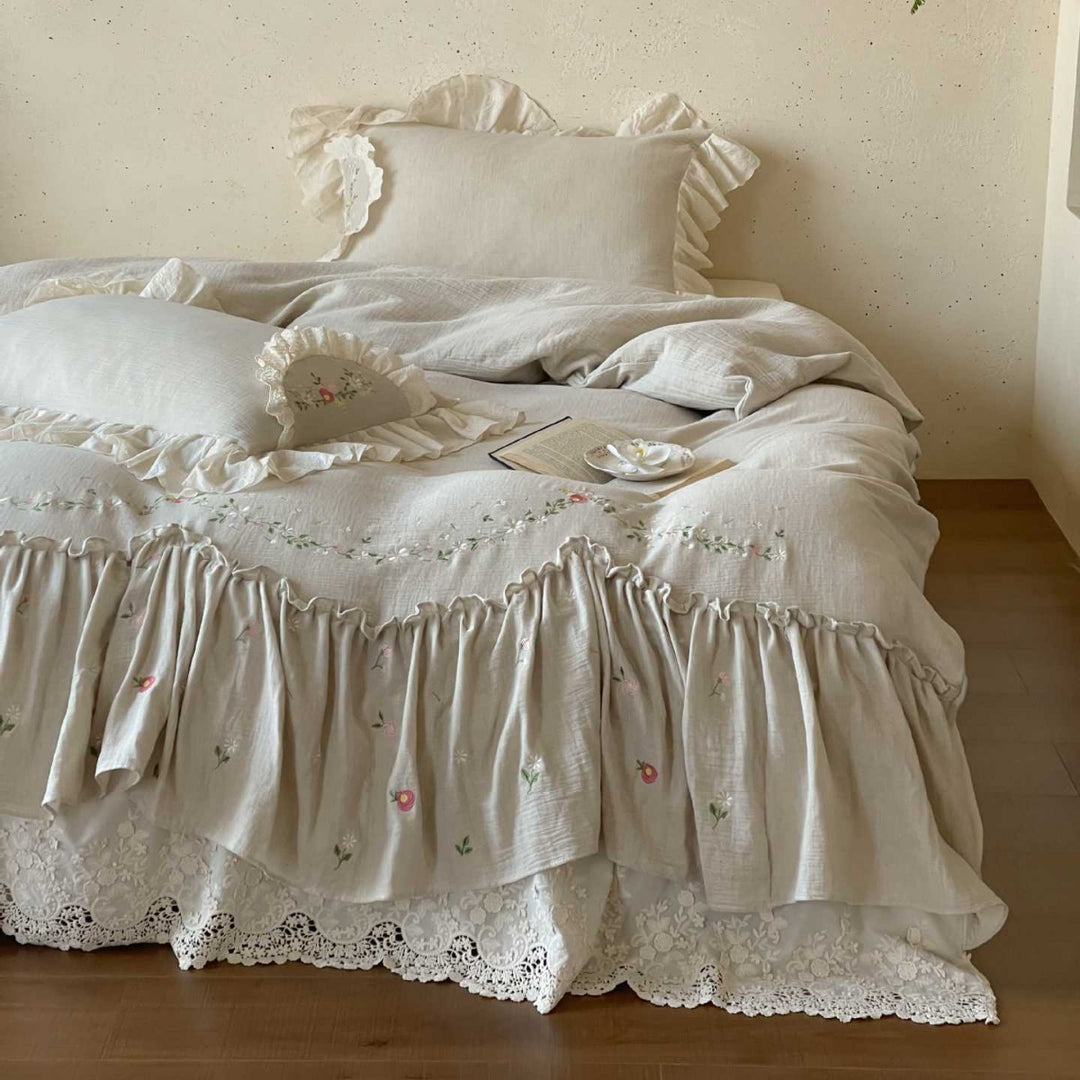 Linen bedspread in country house style with embroidered ruffle and lace edge