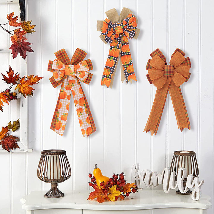Large autumn door bow made of jute with pumpkin print and gingham ribbons