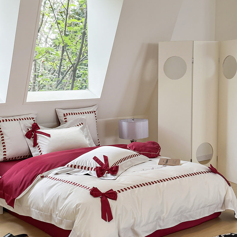 Reversible cotton satin bedding set with decorative bow appliqués