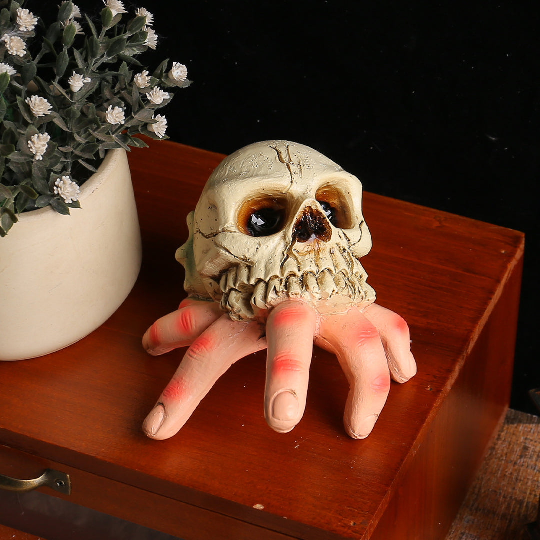 Detailed Halloween decoration sculpture skull with grasping hand