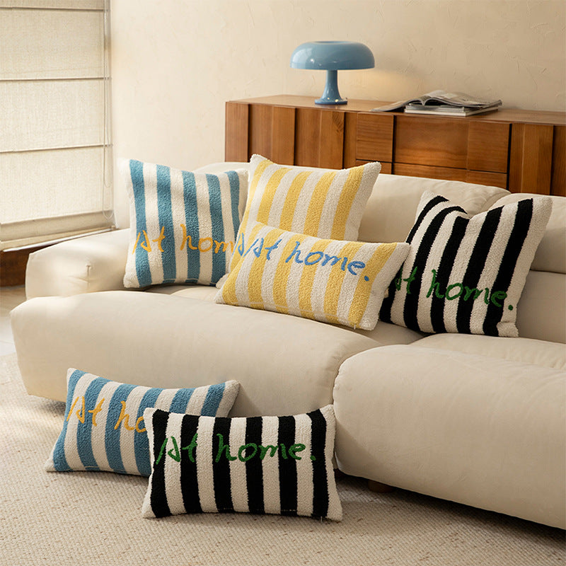 Striped bouclé decorative pillow with embroidered lettering and cuddly filling