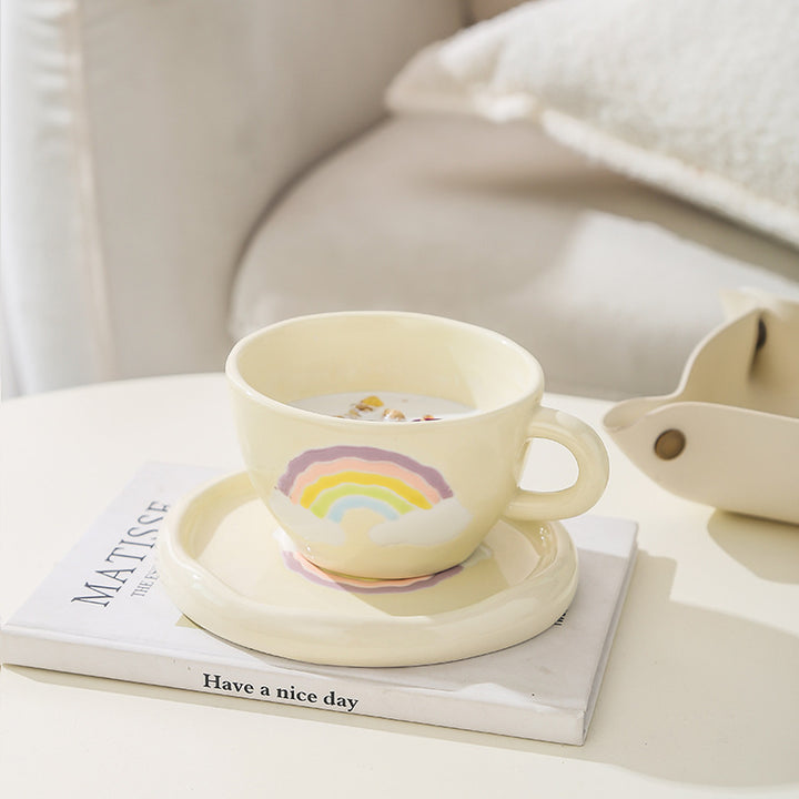 Stoneware breakfast mug with saucer and embossed rainbow design