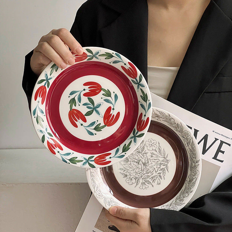 Deep porcelain plate with floral rim ornamentation and contrasting inner mirror