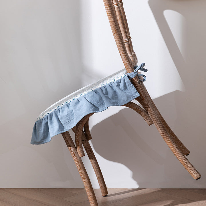 Padded chair cushion with ties, ruffled edge and embroidered hole pattern look Kalsten