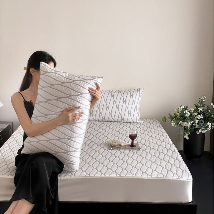 Quilted bedspread set with ginkgo leaf relief, ruffled bed skirt and pillowcases