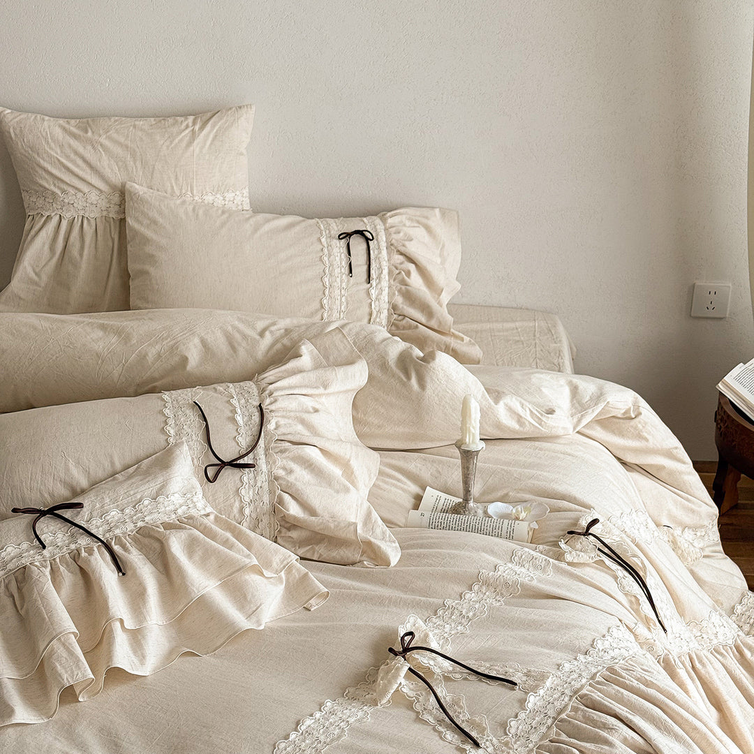 Ruffled bedding set with lace borders and decorative ribbons