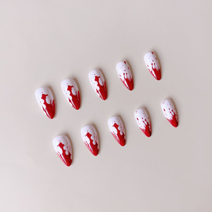 Artificial nail set with blood red inspired design and pointed accents Kalsten
