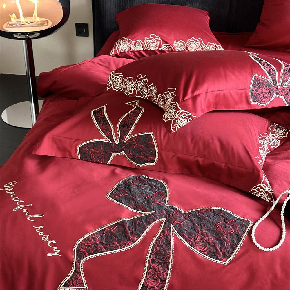 Luxurious satin bedding set with embroidered rose and bow motif
