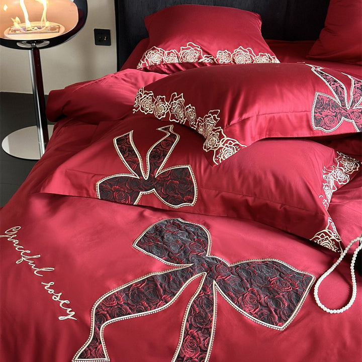 Luxurious satin bedding set with embroidered rose and bow motif