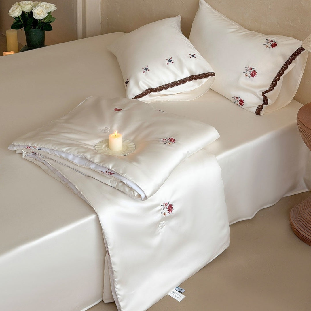 Elegant satin bedding set with fine floral embroidery and lace trim