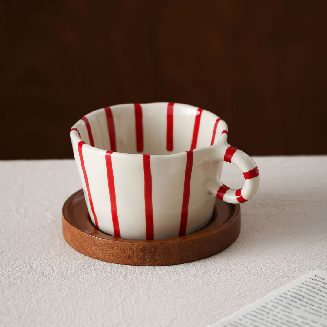Ceramic espresso cup with round wooden coaster and handcrafted stripe pattern