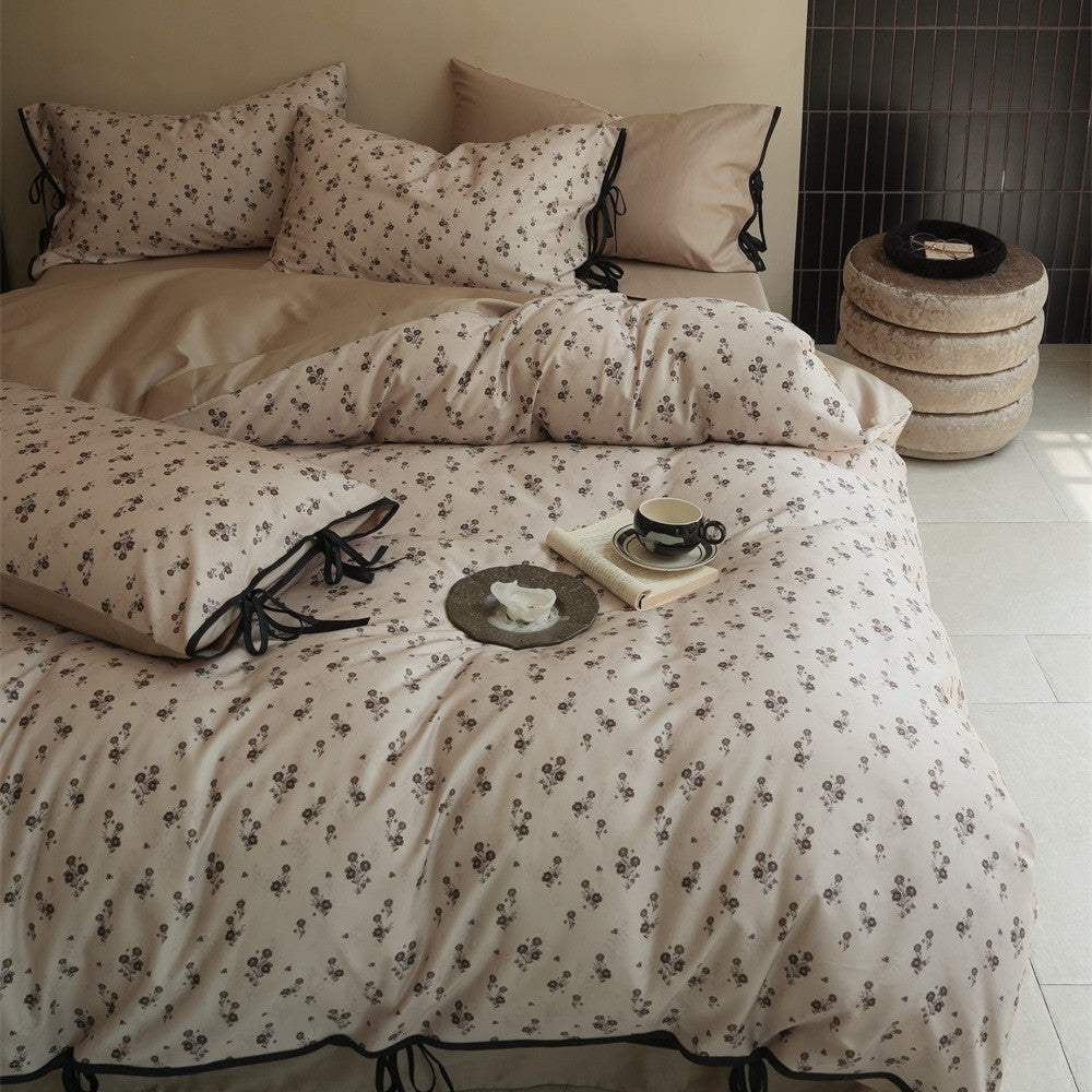 Bedding set made of cotton satin with fine floral microprint and decorative ribbons