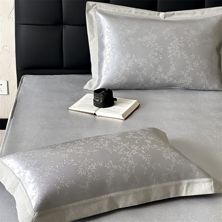 Finely woven satin fitted sheet with floral jacquard relief and reinforced all-round elastic