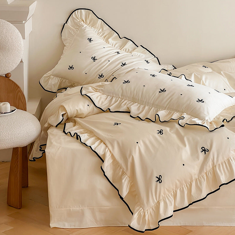 Exclusive bedding set in romantic style with ruffle, subtle bow embroidery, and breathable cotton satin