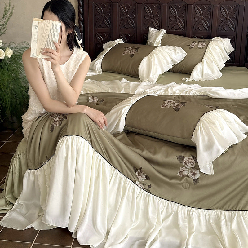 Romantic cotton satin bedding set with ruffled bed skirt and embroidered rose appliqués