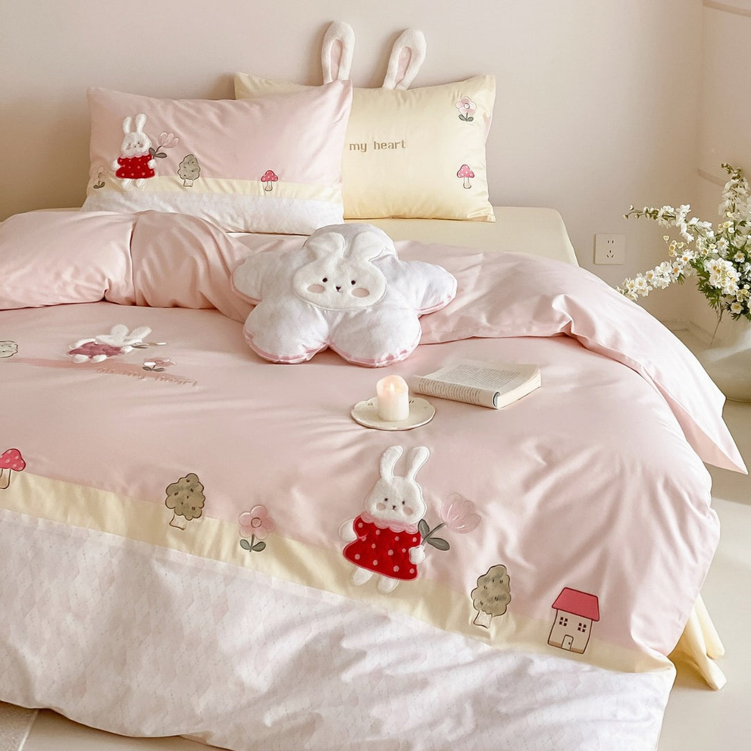 Playful cotton satin bed linen set with embroidered bunny appliqués and plush pillow