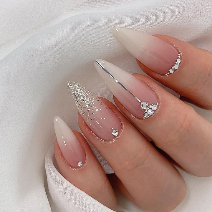 Artificial nail creation with glamorous tips and glitter details Kalsten