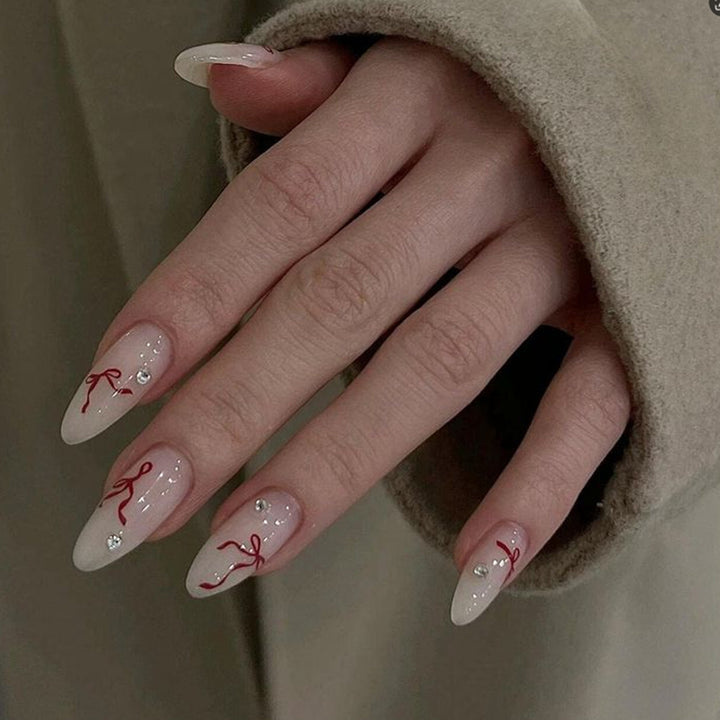 Decorative Stiletto Press-On Nails with Red Ribbon and Gem Embellishments Kalsten