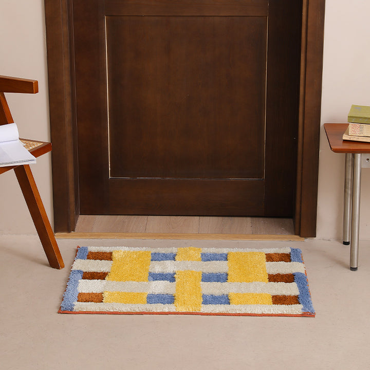 Rectangular tufted door mat with geometric block pattern and non-slip backing Kalsten