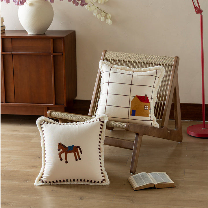 Decorative cushion cover made of cotton blend with fringes, check pattern and embroidered house Kalsten