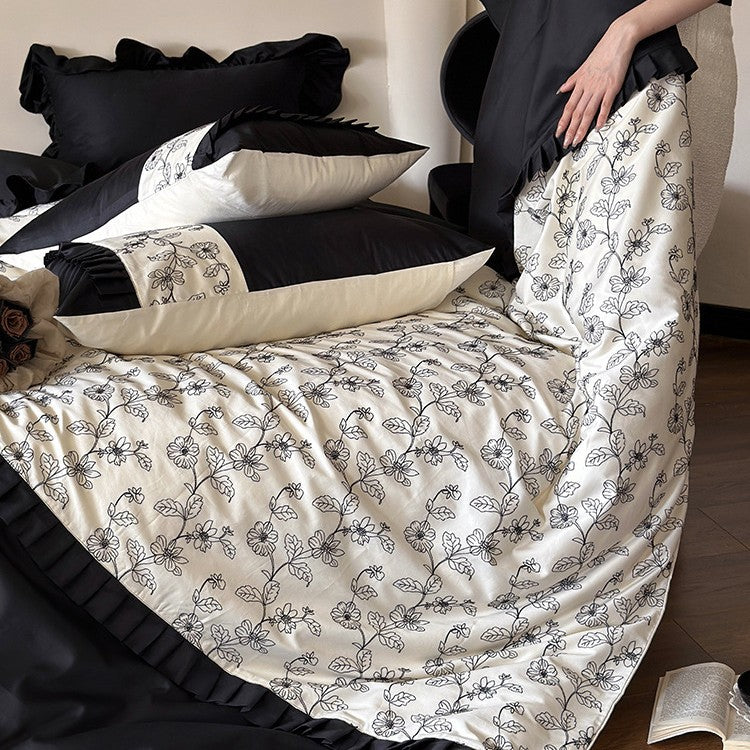 Elegant reversible bedding set made of fine satin with botanical contour print and pleated border