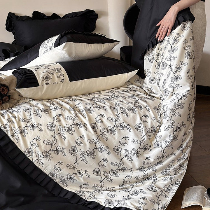 Elegant reversible bedding set made of fine satin with botanical contour print and pleated border