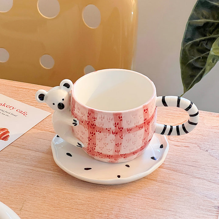 Playful ceramic cup set with koala relief handle and matching saucer