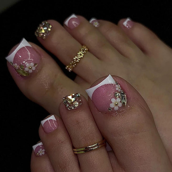 Artistic toenail art with elegant flower and glitter accents Kalsten