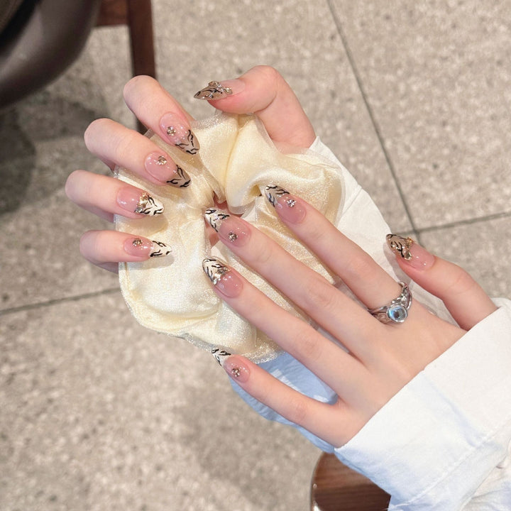 Artistic Press-On Nail Art Set with Luxurious Gold and Black Motifs